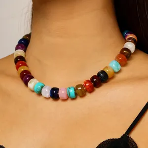 Close-up of vibrant rainbow beaded necklace on model's neck for summer beach style