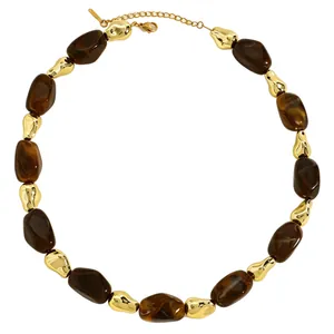 Detailed view of vintage brown resin and gold irregular beaded necklace fashion jewelry