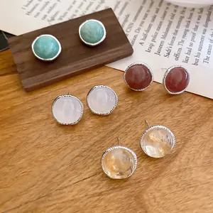 Detailed view of vintage agate stud earrings in four colors on wooden background