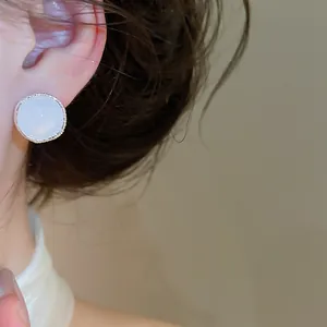 Detailed close-up view of elegant retro white agate stud earring with textured silver border