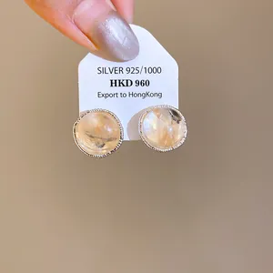 Close-up view of vintage round agate stud earrings with textured S925 silver borders