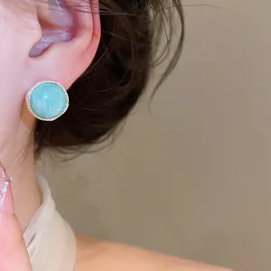 Close-up detail of vintage luxury light blue agate stone stud earrings for women