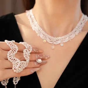 Elegant vintage white glass beaded lace necklace with sparkling crystal charms on model