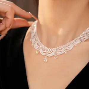 Close-up of white glass beaded lace necklace with iridescent teardrop pendants