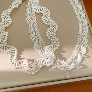 Detailed view of white glass beaded lace necklace with vintage court style and crystals