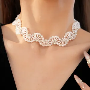 Detail view of white glass beaded wavy choker necklace with crystal accents