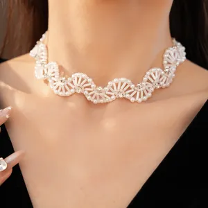 Detail of vintage style white glass beaded wave choker necklace with crystal accents