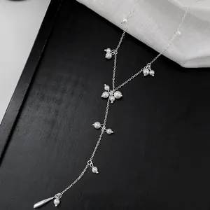 Detail view of French style Y-shaped necklace with starry white pearls and silver chain