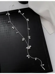 Detail view of this elegant Y-shaped silver necklace with scattered white pearls