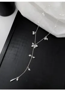 Detail view of a French-style silver Y-shaped necklace with delicate pearls and teardrop charm.