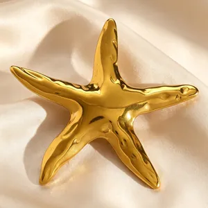 Macro detail of a vintage golden starfish brooch with a high-polish metallic finish