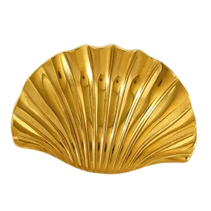 Detailed macro shot of vintage golden scallop shell brooch with polished ridges