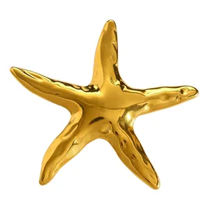 Close-up macro view of a vintage style gold starfish brooch with a polished metallic finish