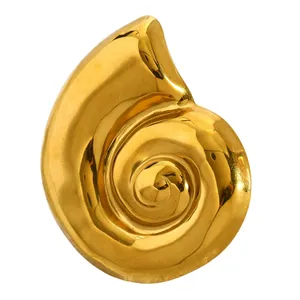 Detailed close-up of a vintage golden snail shell brooch with a high-polished finish