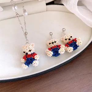 Close-up detail of handmade colorful beaded bear necklace and matching earrings set