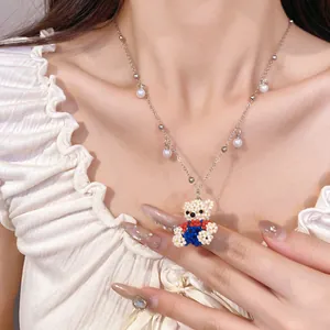 Detailed view of sweet beaded bear pendant necklace featuring delicate pearl tassels.