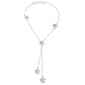 Detailed view of the elegant silver Y-shaped necklace and delicate flower charms
