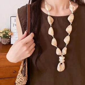 Elegant cream acrylic stone necklace on leather cord for resort style fashion look