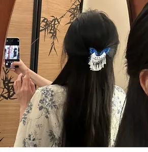 Close-up of vintage butterfly hair clip with silver tassels on black hair
