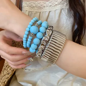 Detail view of Bohemian blue acrylic beaded and silver metal bracelet set on wrist