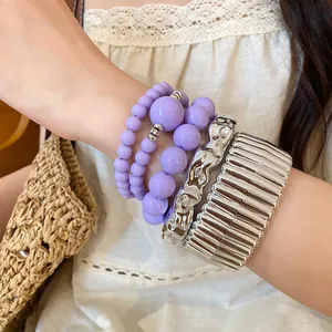 Detailed shot of Bohemian acrylic beads and silver chunky metal bracelet set on wrist
