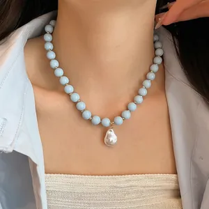 Elegant acrylic light blue bead necklace featuring a white baroque pearl pendant