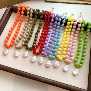 Handmade colorful acrylic bead necklaces with baroque pearl pendants in a wooden frame