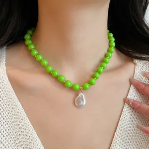 Detailed view of vibrant green acrylic bead necklace with baroque pearl pendant