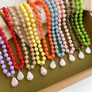 Detailed view of colorful acrylic bead necklaces featuring elegant baroque pearl pendants