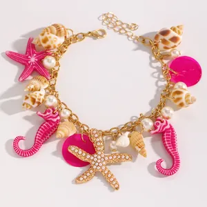 Dettaglio cavigliera boho con conchiglie naturali, ippocampi rosa e stella marina oro