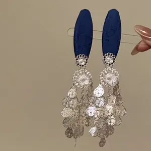 Close-up of New Chinese style hair clip with navy fabric and silver floral tassels