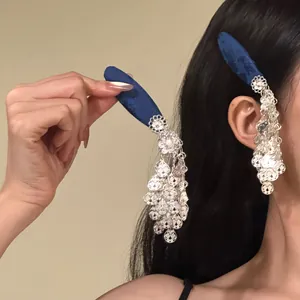 Detailed shot of New Chinese style hair clip with silver tassels and blue fabric base