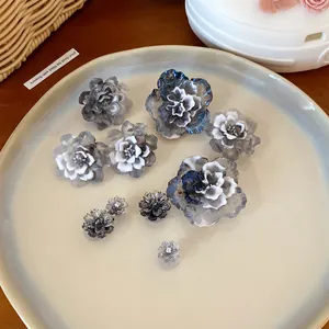 Detailed view of assorted 3D resin flower shoe charms with elegant blue and grey gradient