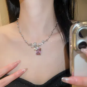 Primo piano di una collana placcata oro 18 carati con zircone rosa quadrato e fiori