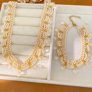 Detail of beaded vintage lace necklace and bracelet set with glass teardrops