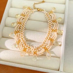 Detailed macro view of vintage palace style beaded necklace with glass teardrop pendants