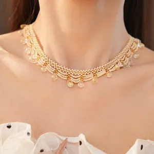 Detail showing the intricate hand-beaded lace pattern and clear teardrop glass pendants