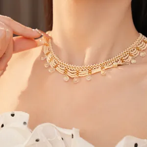Close-up of vintage palace style beaded lace necklace with glass teardrop pendants.