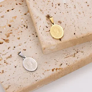 Detail of retro Virgin Mary pendants in gold and silver finishes on stone background.