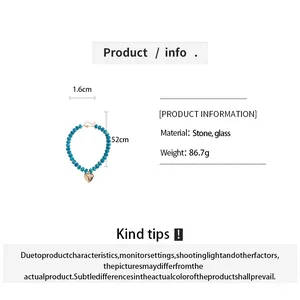 Detail view of turquoise bead necklace with gold heart pendant and specifications