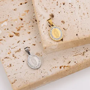 Macro view of gold and silver plated oval Virgin Mary pendants with inlaid rhinestones