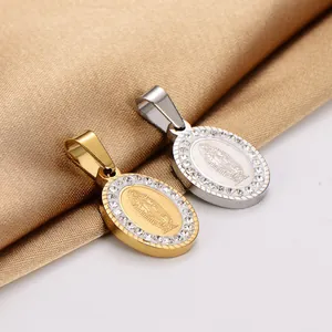 Close-up view of gold and silver oval Virgin Mary pendants with inlaid rhinestones