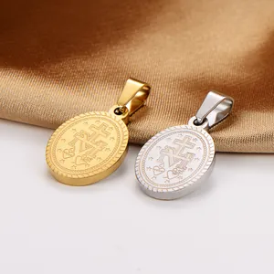 Detailed view of vintage stainless steel oval pendants with religious symbol engravings