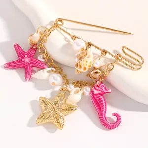 Detailed macro view of ocean-themed brooch with starfish seahorse and shell charms