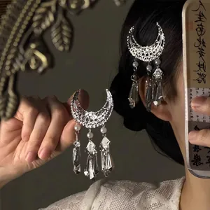Détail de la barrette lune argentée avec perles élégantes et longs glands métalliques