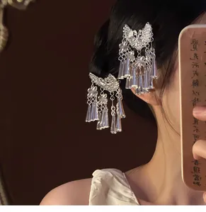 Vue détaillée de pinces à cheveux papillon argentées portées sur un chignon latéral