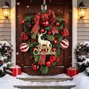 Festive Christmas reindeer teardrop swag with red ornaments and gold Merry Christmas sign.