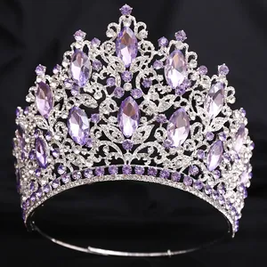 Detailed view of a luxurious silver bridal tiara with sparkling purple crystals.