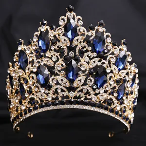 Close-up of luxury bridal tiara with navy blue crystals and leaf-shaped gold metalwork