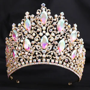 Detailed view of luxury European bridal crown with iridescent crystals and gold leaves.